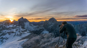 photographer-capturing-the-sunset-in-the-mountains-